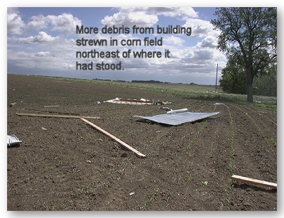 Photo of additional debris from building strewn across corn field to the northeast.