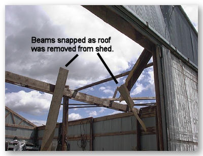 Photo of beams snapped as roof was removed from shed by strong winds.
