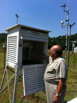 Mr. McCravy pictured next to his weather observing equipment.