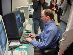 Lead forecaster Chris Darden finalizes work on the first Zone Forecast to be issued from Huntsville as several members of the local news media look on. 