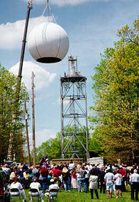 Onlookers watch as the dome is raised onto the new Hytop radar at a dedication ceremony in April 1997.