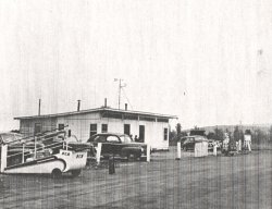 Facing north-northeast toward the Huntsville Municipal Airport Administration Building on May 13, 1946.  The instrument shelter can be seen on the right side of this picture, on the northeast side ofhte building.  Wind vane and anemometer are on top of the building.