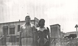 Joe and Ruby Cambron standing next to their Cotton Region shelter in August 1941.  The site's wind eqipment, directly behind them, is on top of the Texaco station they owned.
